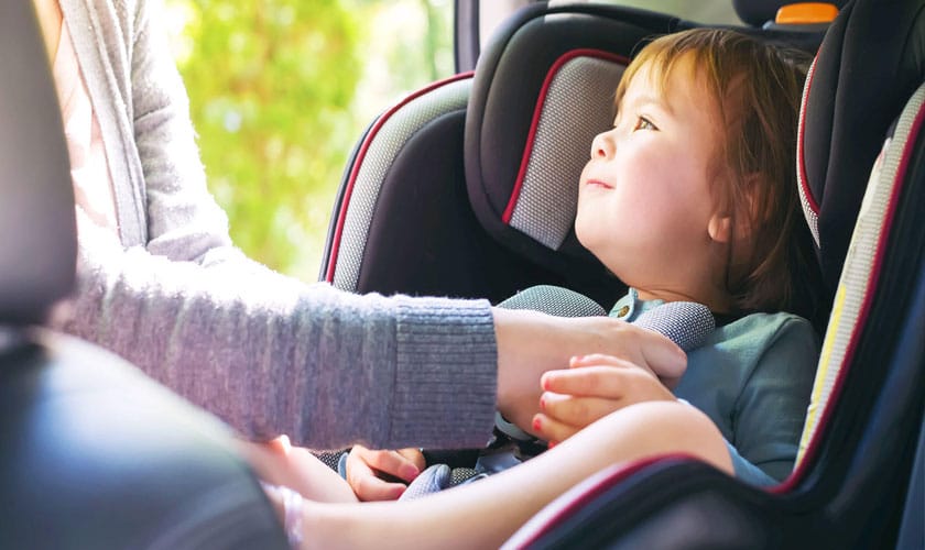 infant sitting in forward-facing car seat
