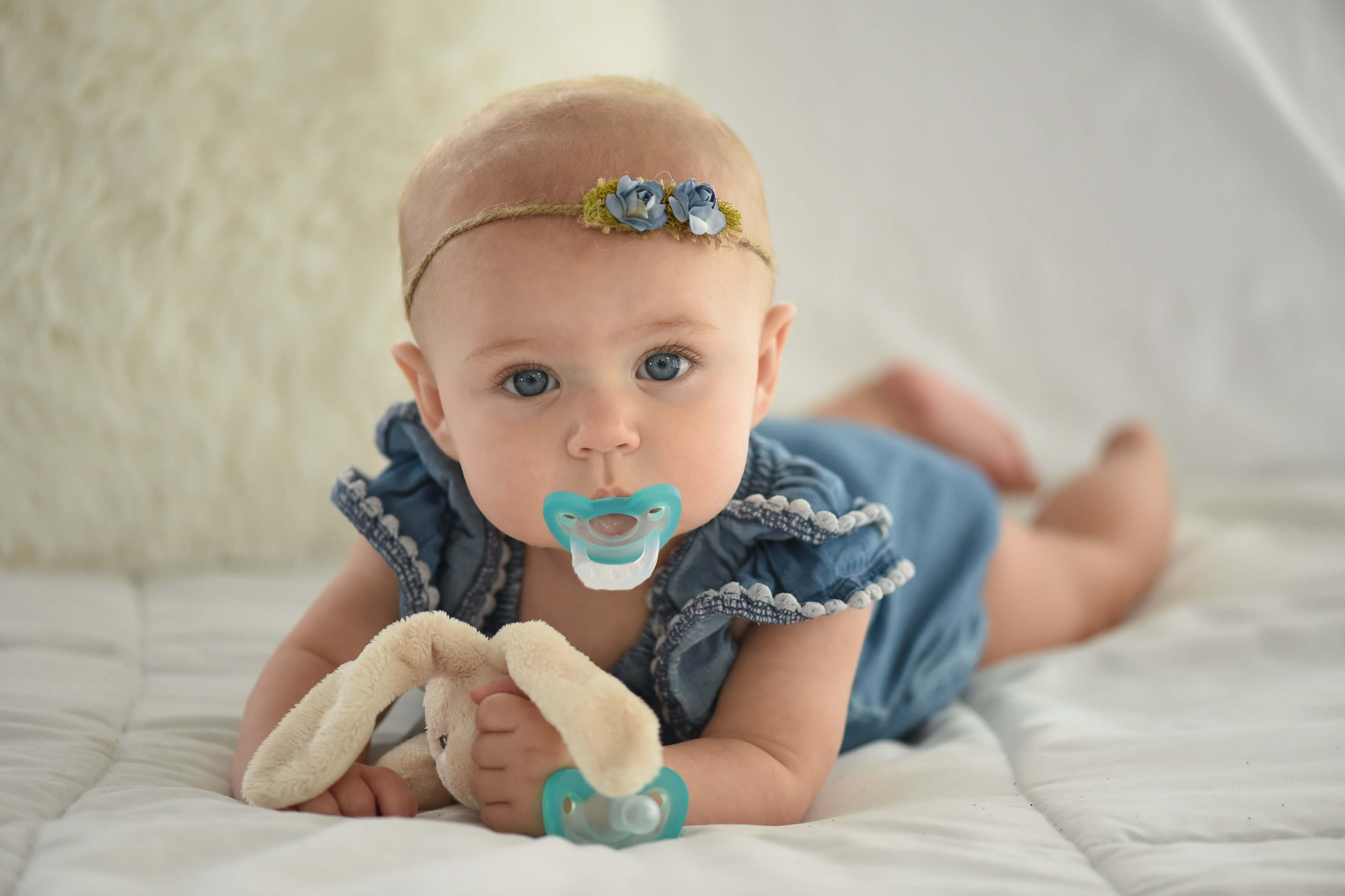 Baby with blue ribbon